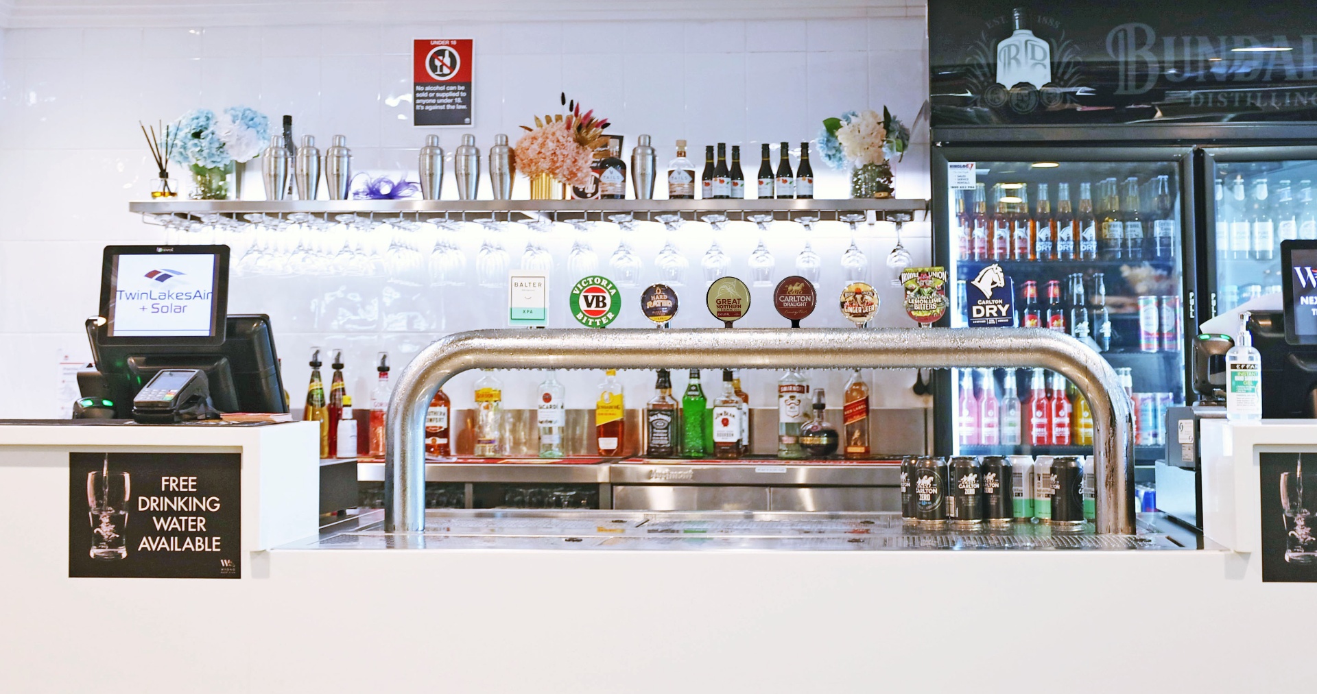 Bar with beer taps, spirits and fridge of drinks