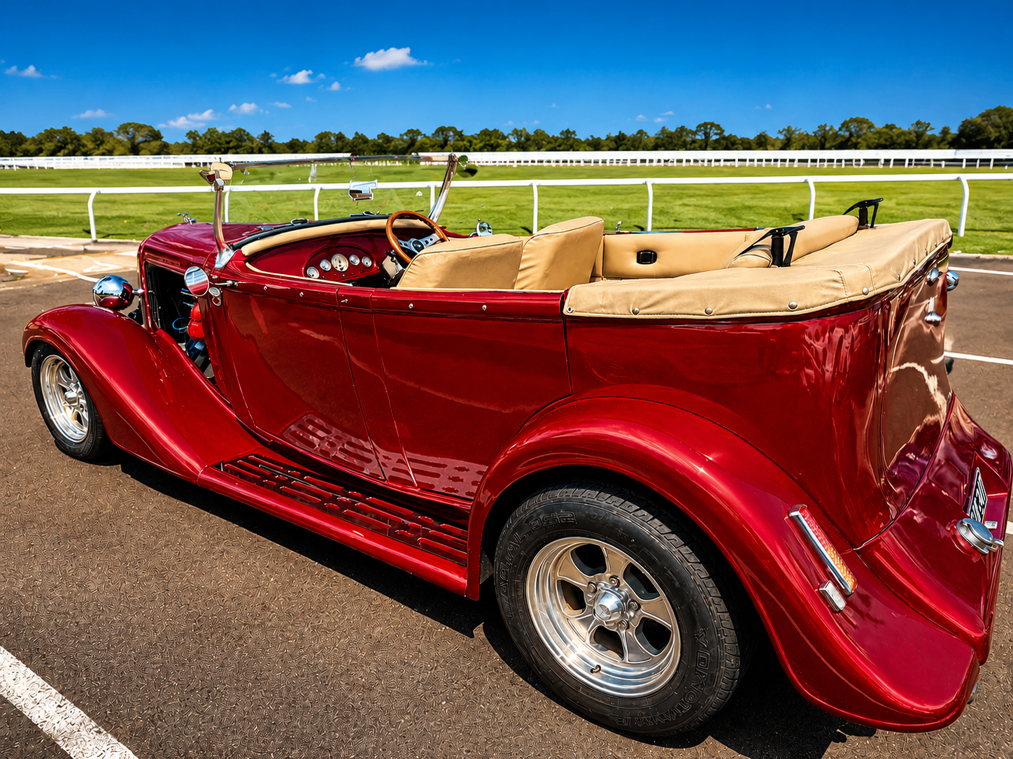 Red convertible hot rod at the racecourse