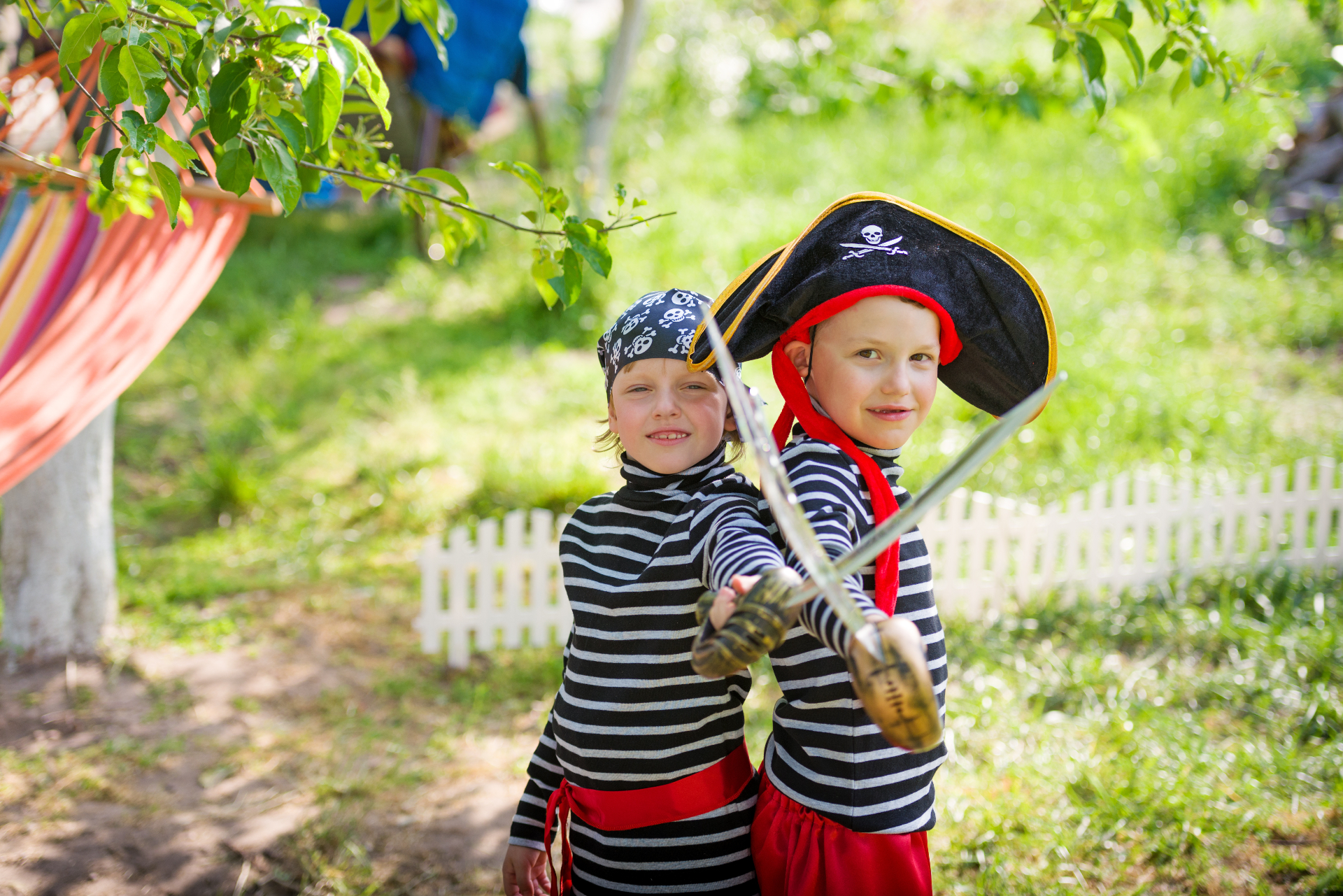 Two kids dressed as pirates with swords