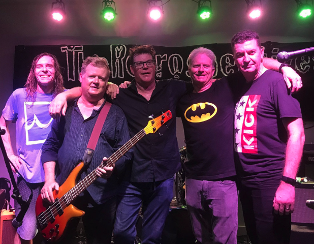 The Retrospectives band posing on stage